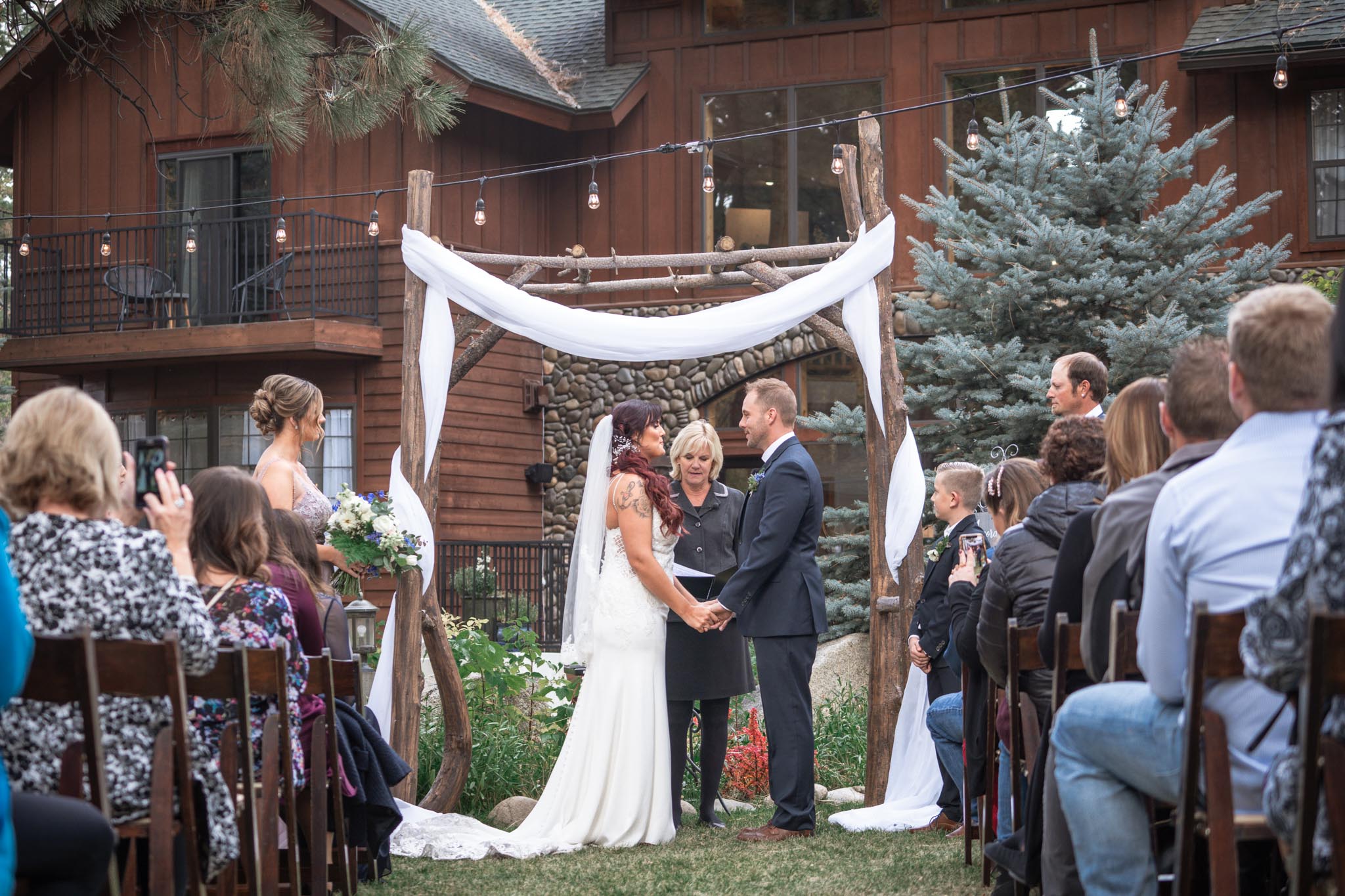 Black Bear Lodge Wedding | Jackie + Rick Saying vows in front of the arch at Black Bear Lodge