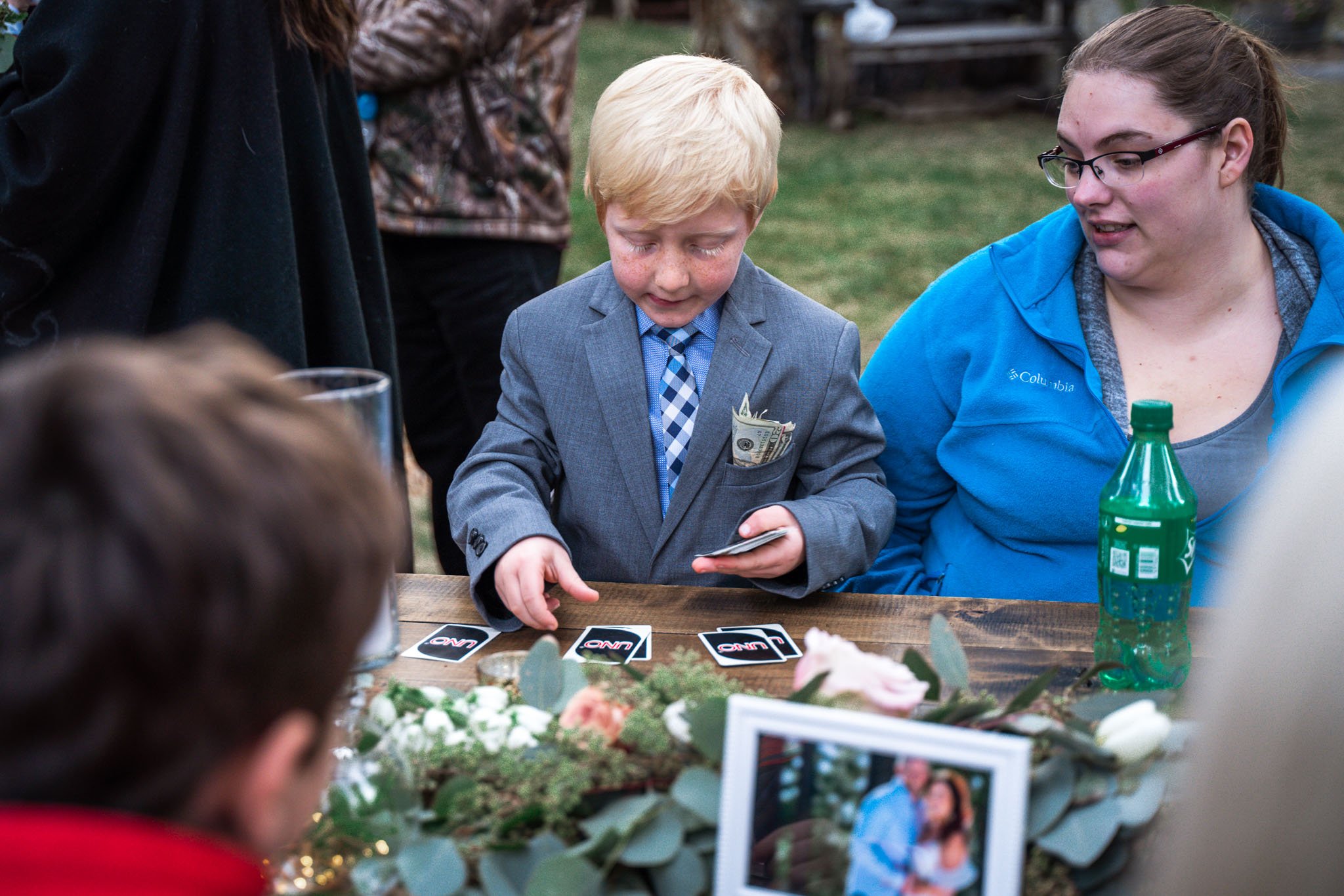 Black Bear Lodge Wedding | Jackie + Rick Blonde boy does card magic tricks at the reception