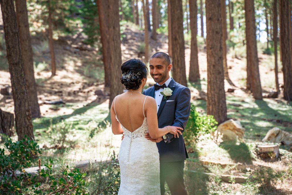 Lake Tahoe Wedding Photography Portfolio Groom smiles as he sees his wife in her wedding dress for the first time