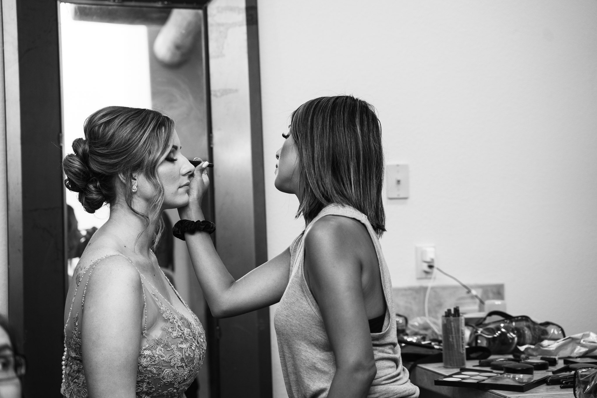 Black Bear Lodge Wedding | Jackie + Rick Makeup artist putting makeup on a bride