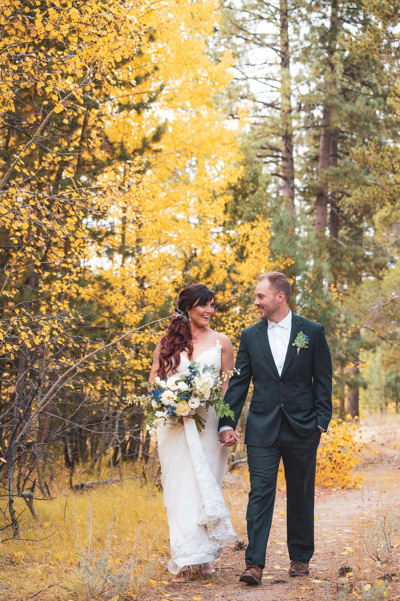 Black Bear Lodge Wedding | Jackie + Rick Bride and groom walking hand in hand between the aspens