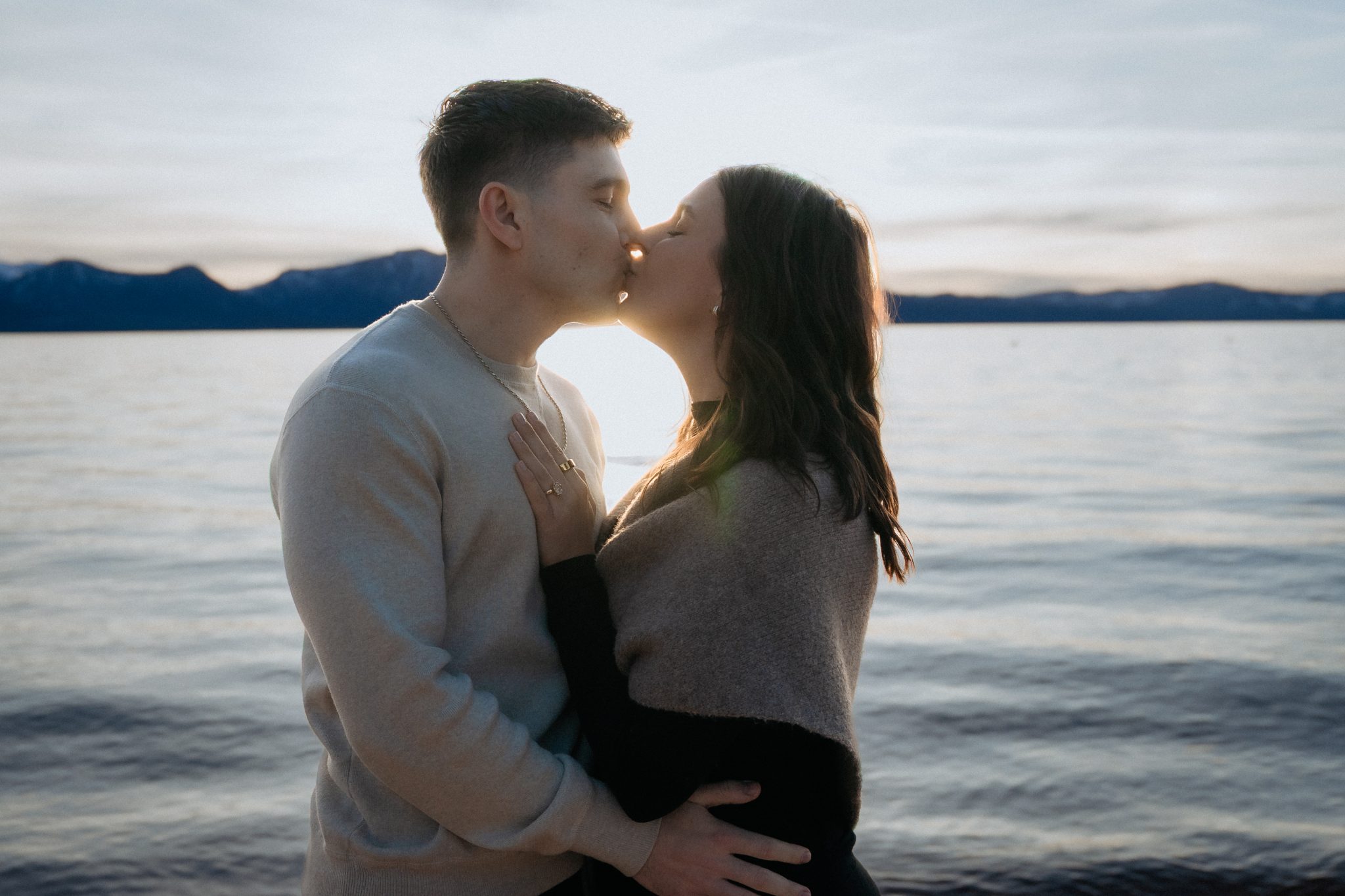 Edgewood Tahoe couples photography featuring a romantic sunset embrace along the shoreline of Lake Tahoe.