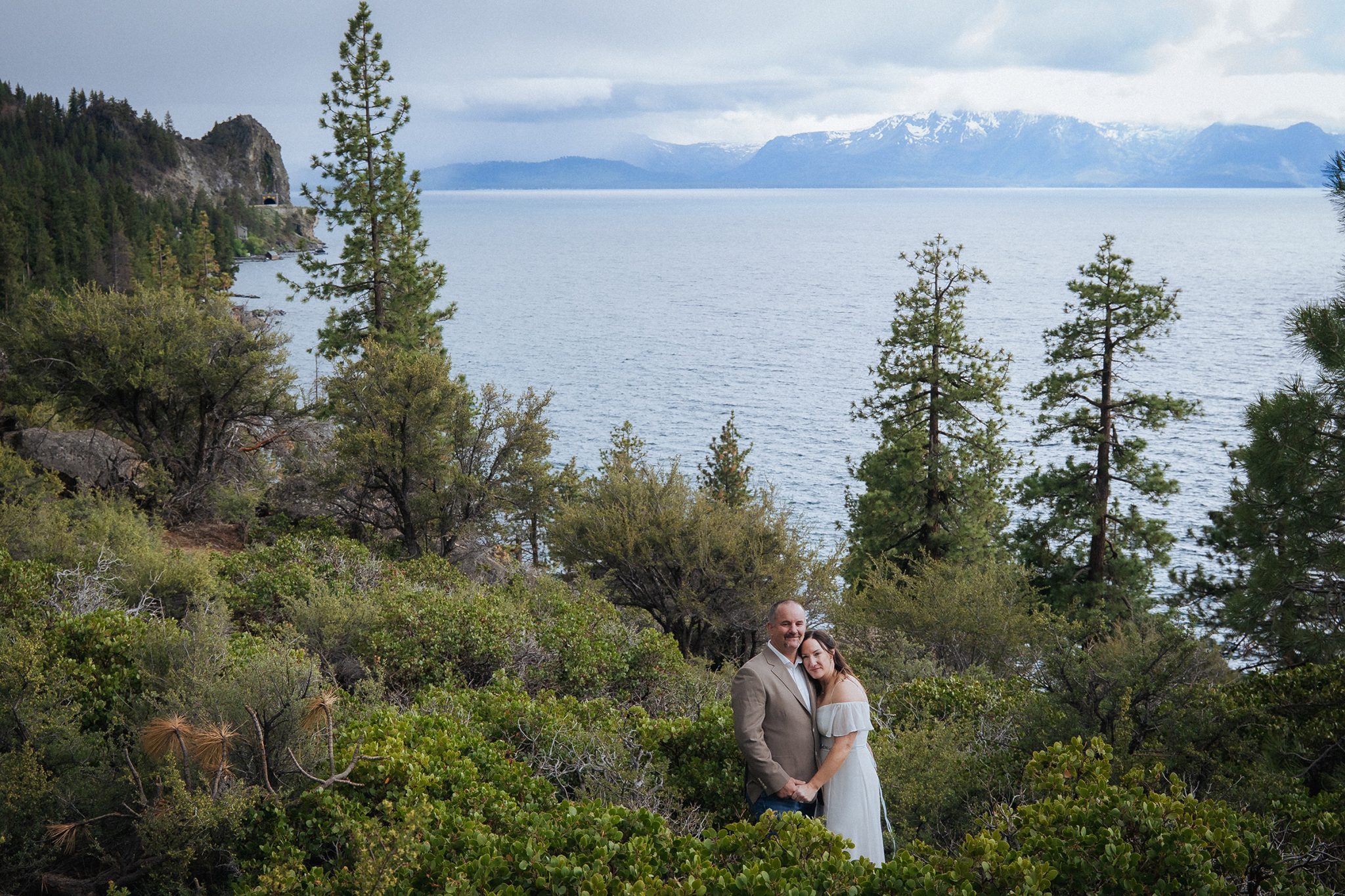 couple sharing a quiet moment on a scenic Lake Tahoe overlook, demonstrating how to feel comfortable in front of the camera and enjoy natural wedding photography