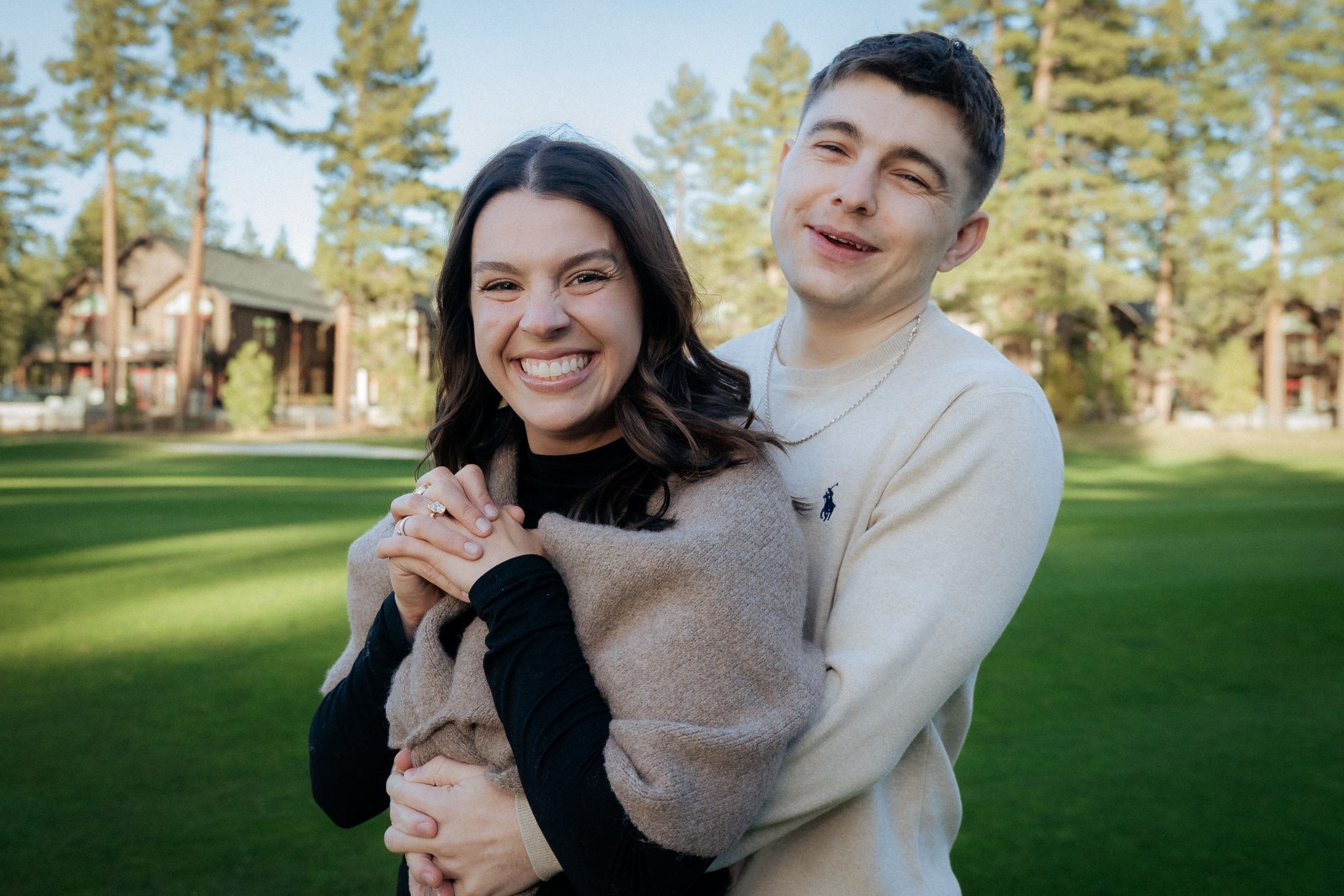 South Lake Tahoe proposal couple celebrating their engagement at Edgewood Tahoe Resort with scenic mountain views.