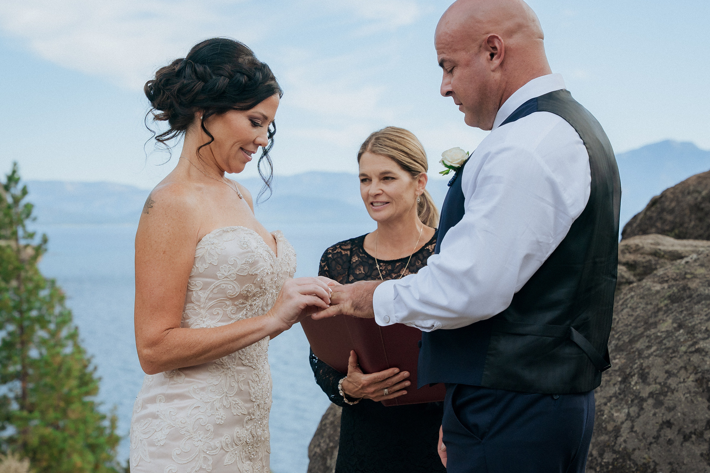 Logan Shoals intimate wedding ceremony with a bride and groom exchanging vows with an officiant overlooking Lake Tahoe and scenic mountain views.