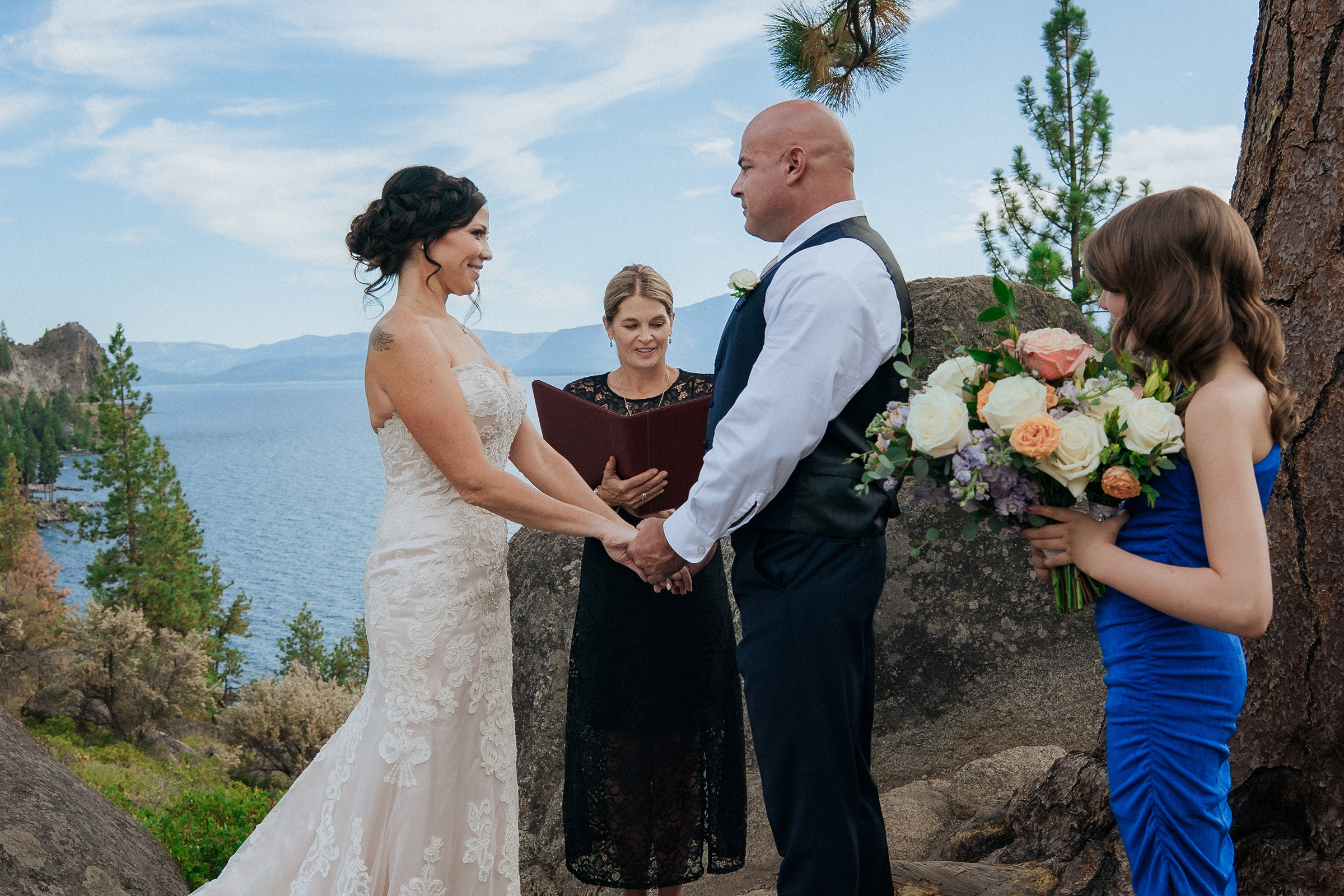 Logan Shoals small wedding ceremony with a bride and groom exchanging vows with family and friends overlooking Lake Tahoe and scenic mountain views.